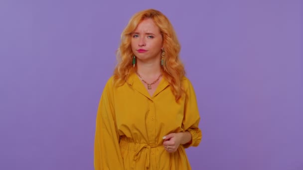 Upset girl in yellow dress showing thumbs down sign gesture, disapproval, dissatisfied, dislike — Stock Video