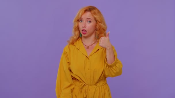 Vöröshajú elegáns lány sárga ruhában mutatja hüvelykujj fel és bólogatás jóváhagyása, sikeres jó munka — Stock videók
