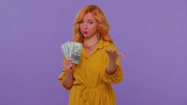 Proud arrogant rich stylish girl holding money cash in dollars banknotes, smiling, looking at camera — Stock Video