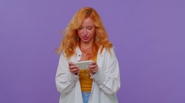 Endişeli komik bağımlı kadın cep telefonuyla yarış oyunları oynuyor.