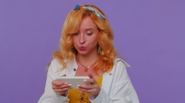 Endişeli komik bağımlı kadın cep telefonuyla yarış oyunları oynuyor.