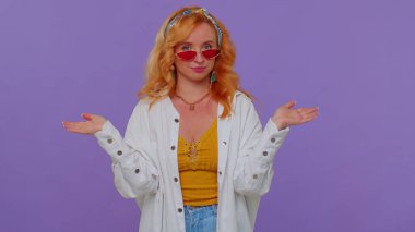 Beyaz tişörtlü, güneş gözlüğü takan, mor duvarda büyüleyici bir gülümsemesi olan baştan çıkarıcı, neşeli, şık bir kız.