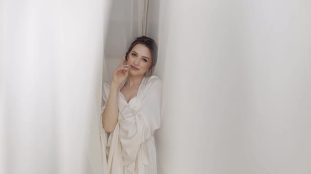 Bride in boudoir dress near window, wedding morning preparations, woman in night gown and veil — Stock Video