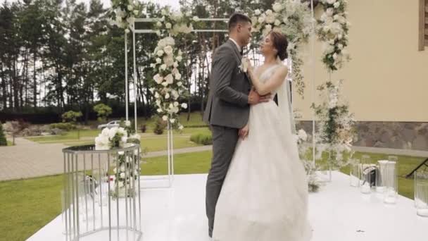 Newlyweds, caucasian groom with bride walking, embracing, hugs in park, wedding couple — Stock Video