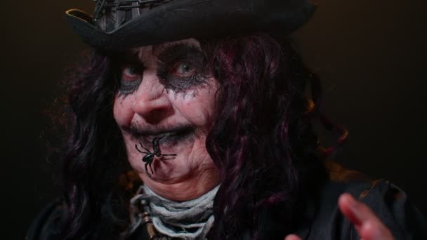 Creepy scary mature woman grandmother with Halloween stylish witch makeup making terribly faces — Stock Video