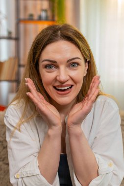 Orta yaşlı bir kadın evdeki koltukta kameraya şaşkınlıkla bakıyor, vay canına diyor ve büyük bir heyecanla tepki veriyor. Genç bir kız, beklenmedik bir an ya da haberle şaşkına dönmüş bir şekilde şaşkınlık ve görünür bir şok yaşıyor..