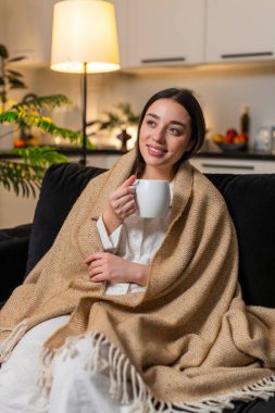 Geceleri genç bir kadın beşiğinde çay kupası sıcak avuç içleri yavaş yavaş nefes al sakin huzur. Akşamları kanepede beyaz bir kız arkasına yaslanıyor. Nazik gülümseme dinleniyor. Rahatlığın tadını çıkarıyor..