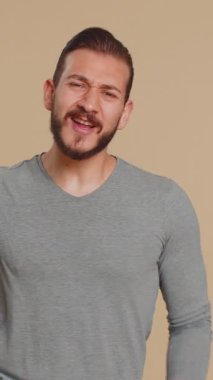 Mutlu Lübnanlı adam bağırıyor, el kol hareketi yapıyor başarıyı kutluyorum, kazanıyorum, doğum günü, piyango hedefine ulaşıyorum. İyi haber. Bej renkli stüdyo geçmişi olan Ortadoğulu bir çocuk.