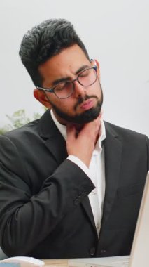 Hintli işadamı boğazı ağrıdığı için hastalandığını hisseder. Ofiste çalışırken boynuna ağrı girer. Resmi takım elbiseli erkek Hindu nezle olmuş, virüs kapmış.