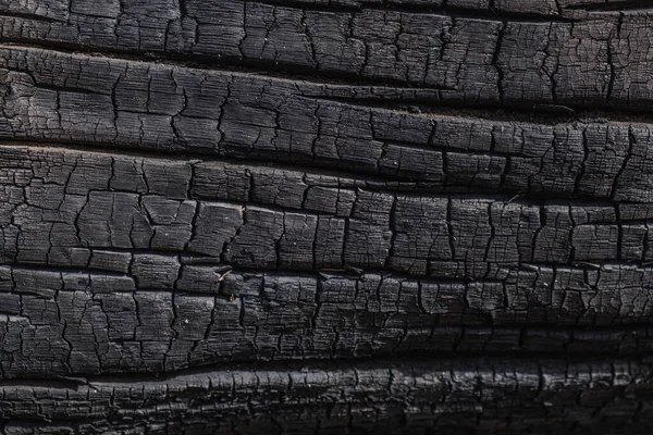 Zwęglone czarne drewno jako tło. Tekstura. — Zdjęcie stockowe