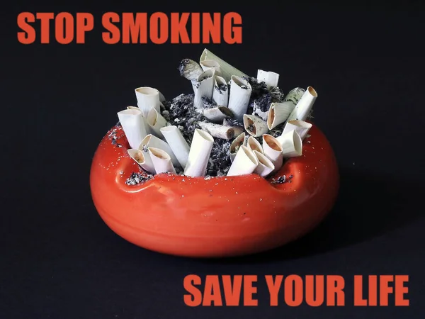 Ashtray with cigarette butts and the inscription \