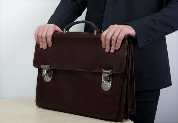 Portrait of successful business man with bag in grey background and space for text, Closeup Of Businessman Holding Briefcase Going To Work, man walked with bag, Business man hands with briefcase — Stok Foto