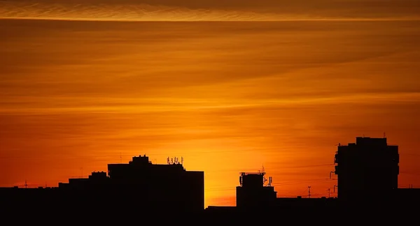 Silhouette of buildings in orange sunset, buildings silhouettes in colourful sunset, evening in the city, dramatic colourful sunset sky in the Vilnius with buildings silhouettes, artistic photo