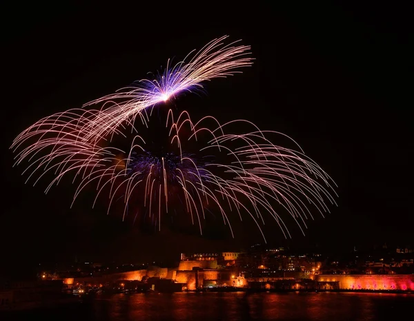 Multicolored fireworks in Valletta isolated in dark background with the place for text, Malta fireworks festival, 4 of July, Independence day, New Year, explode, fireworks in Malta — Stock Photo, Image