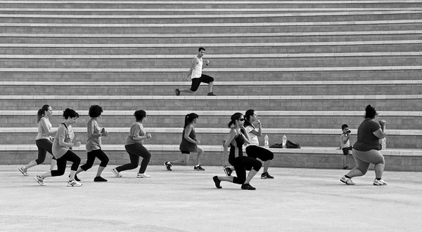 Kalkara, Malta - 11 de janeiro: grupo de pessoas treinando em Kalkara, Malta, em 11 de janeiro de 2015. Mulher treinando com o líder em Smart City Malta. Grupo de mulheres a treinar durante o dia. Foto em preto e branco — Fotografia de Stock