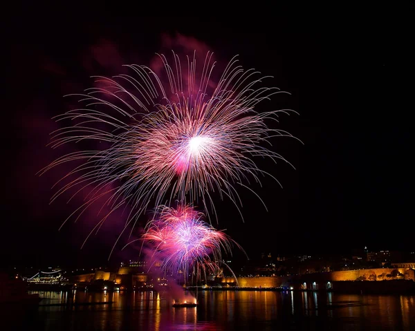 Colorful fireworks explode in Malta in dark sky,Malta fireworks festival, 4 July, Independence day, fireworks explode, New Year, fireworks in Valletta isolated in dark background with place for text — Stock Photo, Image
