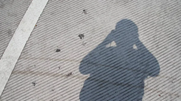 shadow of a man taking a photo