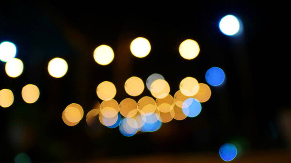 Abstract bokeh colorful of the lights in the night in market party at city center. New year or holidays background concept.