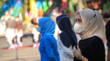 Geleneksel kıyafet ve maskeler takarak bir tören düzenleyen vatandaşlar, 25 Ağustos 2021