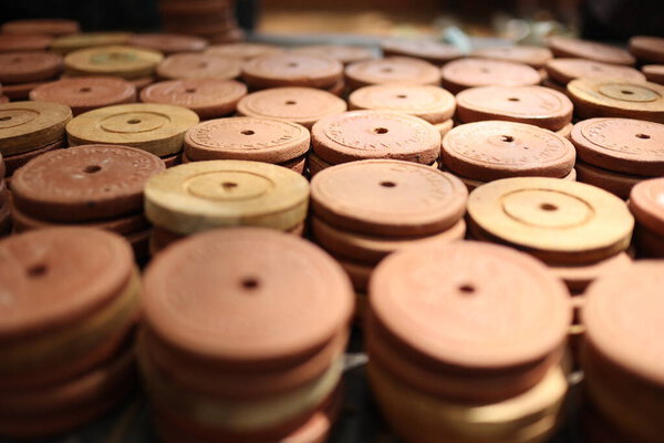 A collection of coins made of clay or pottery, used as a means of exchange in special markets, to buy culinary products