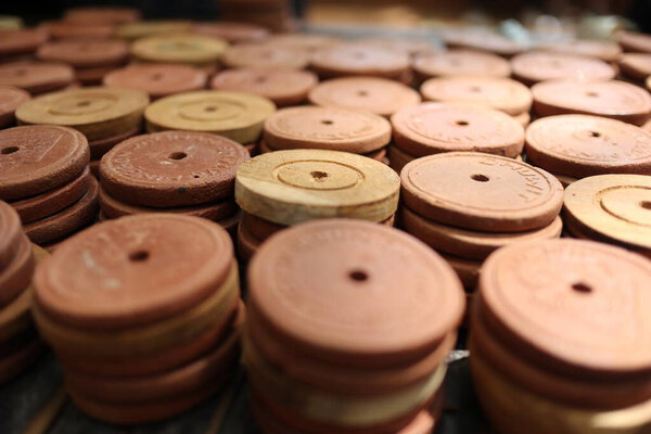 a collection of ceramic coins, made from clay or earthenware, to be used as a means of exchange in special markets, to purchase culinary products