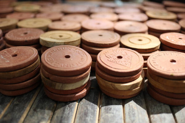 a collection of ceramic coins, made of clay or earthenware, used as a means of exchange in special markets, to purchase culinary products