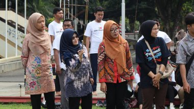 Birlikte duran bir grup insan. Hepsi gülümsüyor ve gösterinin ya da ilginç aktivitenin tadını çıkarıyor gibi görünüyorlar, Pekalongan Endonezya, 14 Ağustos 2025