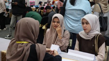 Genç iş arayanlar, 27 Ağustos 2025 'te Pekalongan Endonezya' da özgeçmiş sunarken ve kariyer fırsatlarını tartışırken iş fuarında mülakatlara katılıp sıraya girdiler.