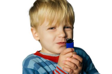 Little boy is played with a lighter clipart