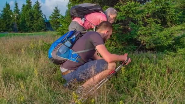 Slow Motion Couple Hikers Crouched While Touching Vegetation Hike — Stock Video