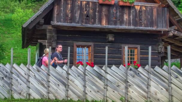 Young Hikers Walking Remote Wooden Cottage Trekking Route Amidst Beautiful — Stock Video