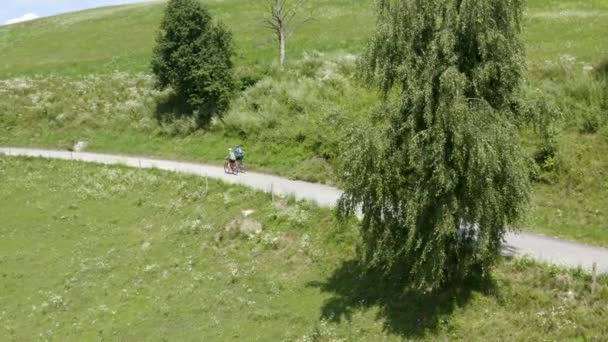 Sartén Aérea Dos Personas Montando Bicicletas Una Carretera Rural Que — Vídeos de Stock
