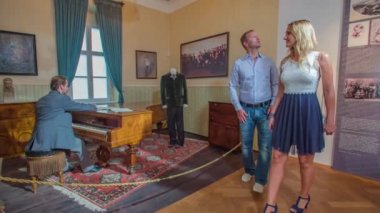 Hugo Wolf Müzesi 'nde piyano çalan, yürüyen ve gözlemleyen beyaz bir çift.