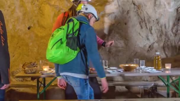 Turistas Vistiendo Coloridos Equipos Protección Sientan Almorzar Mesa Dentro Cueva — Vídeos de Stock