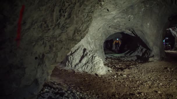 Underground Cave Mountain Biking Dark Mysterious Cave Path Slow Motion — Stock Video