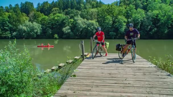 Two Bikers Leaving Wooden Deck Appreciating View Beautiful River — Stock Video