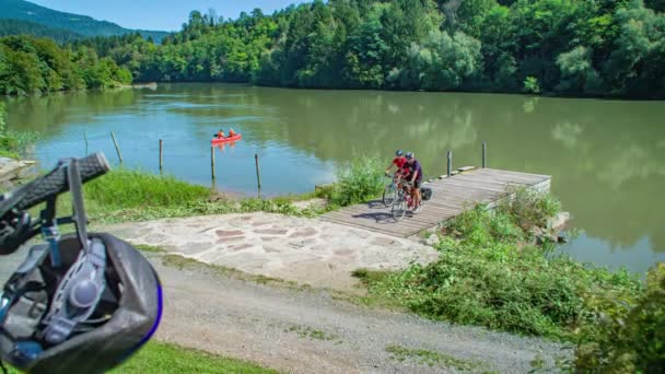 Couple Ride Bikes Pond Pier Pull Back Bikers Sitting Slomo — Stock Video