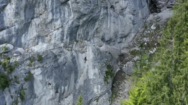 Aerial Drone Footage Showing Mountaineer Traversing Steep Rocky Mountainous Terrain — Stock Video