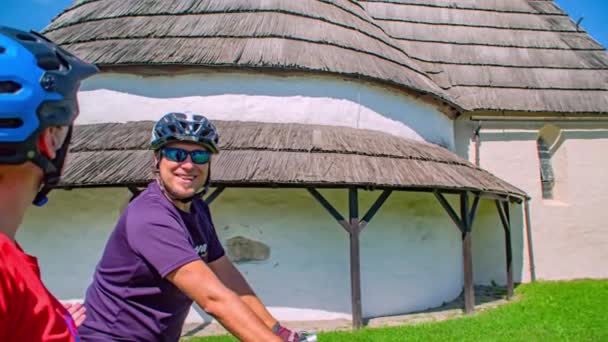 Счастливая Пара Велосипедистов Останавливается Увидеть Романскую Церковь Святого Иоанна Крестителя — стоковое видео