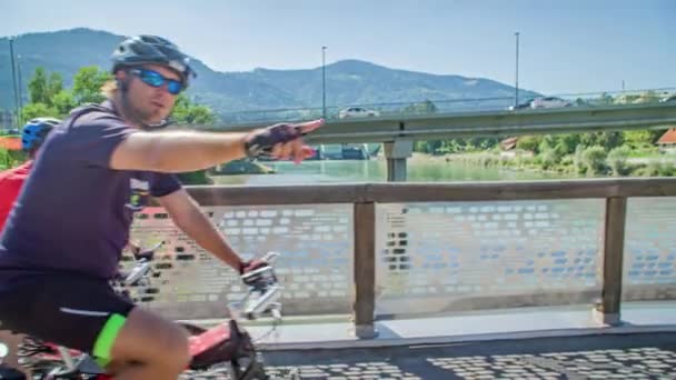 Slow Motion Shot Couple Bikers Crossing Bridge River Pointing Landscape — Stock Video