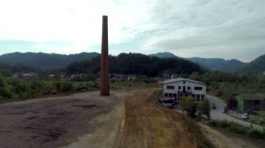 town and a chimney that lies in the middle of it