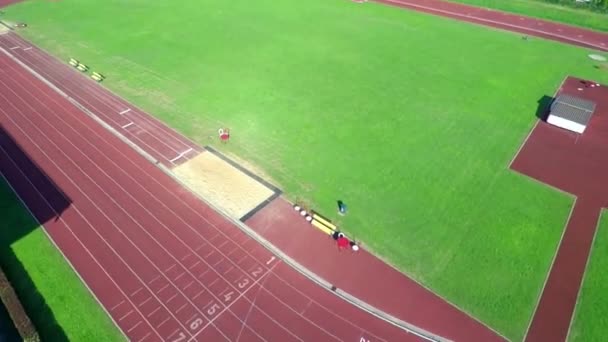 Running track in a beautiful summer day — Stockvideo