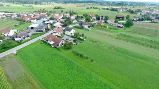 Small village with its surrounding fields — Stockvideo