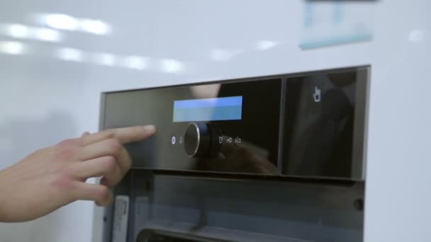 A man inspects equipment in kitchen store — Stock Video