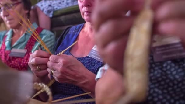 Women skilfully weaving straw in a space us knitting room — Stock Video