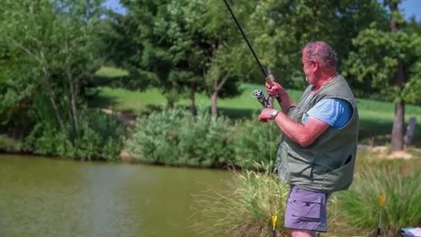 Fisher fishing on lake coast — Stock Video