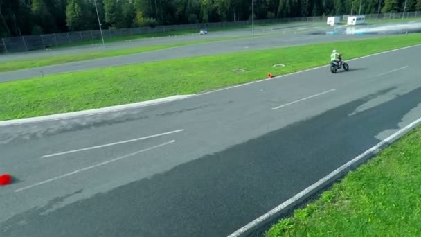 Montar en moto en pista de carreras — Vídeo de stock