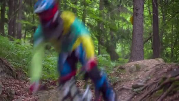 Extreme downhill riders jumping — Stock Video