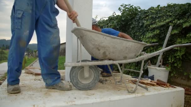 Worker taking  concrete out of wheelbarrow — Stock Video