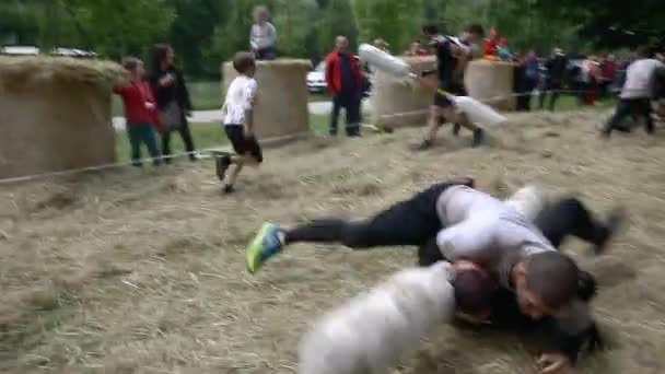Pessoas correndo através de varas de pugil curso de obstáculo — Vídeo de Stock